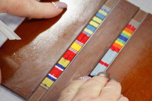 Securing the backing on a ribbon rack